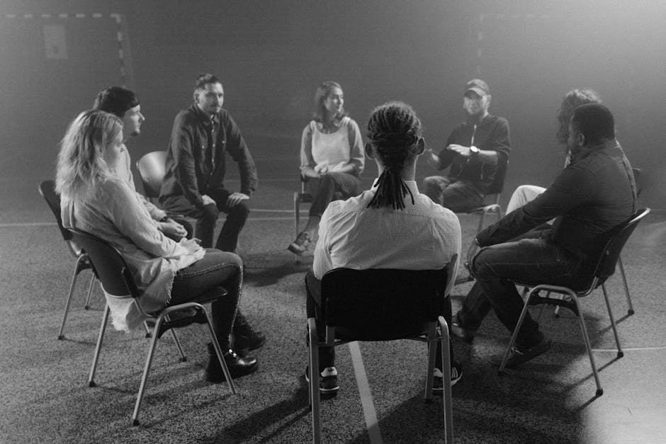 A diverse group of people sitting comfortably in a circle during a yoga session.